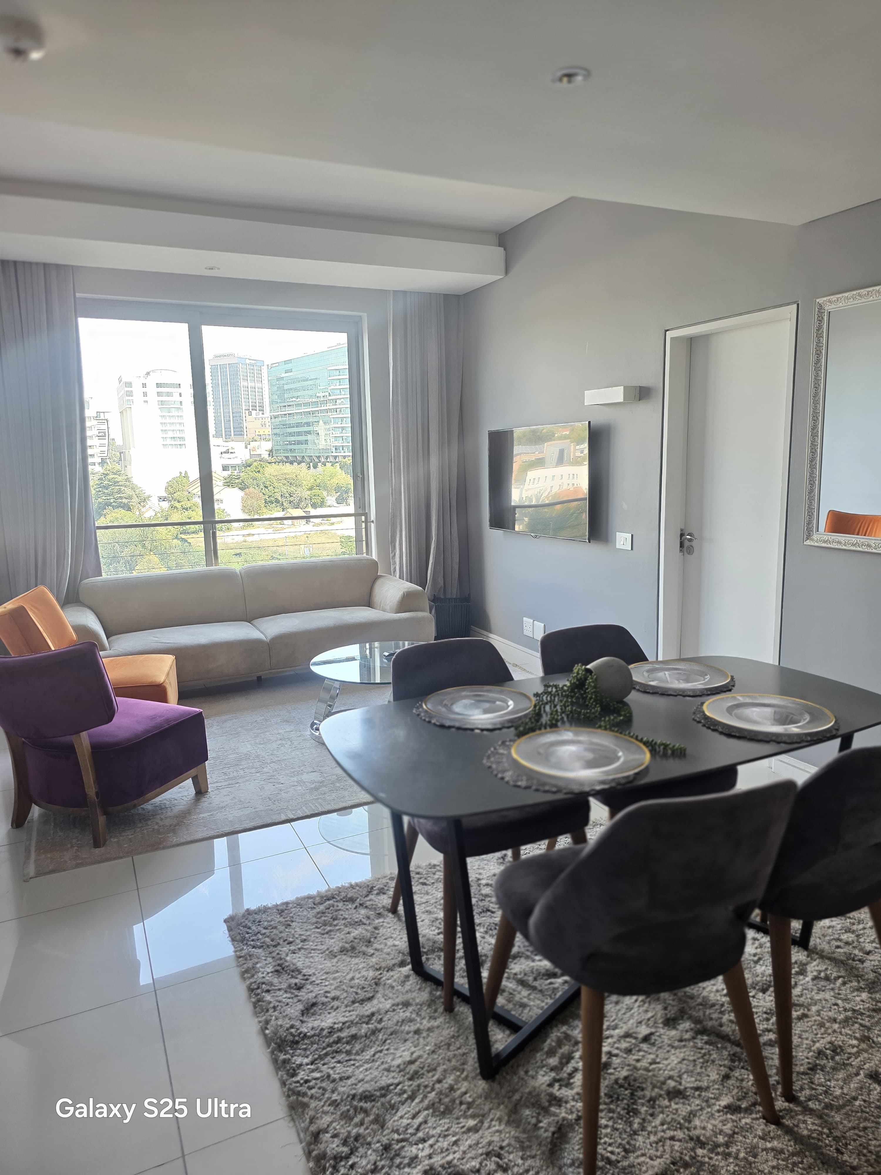 Spacious living room with dining area and panoramic city views