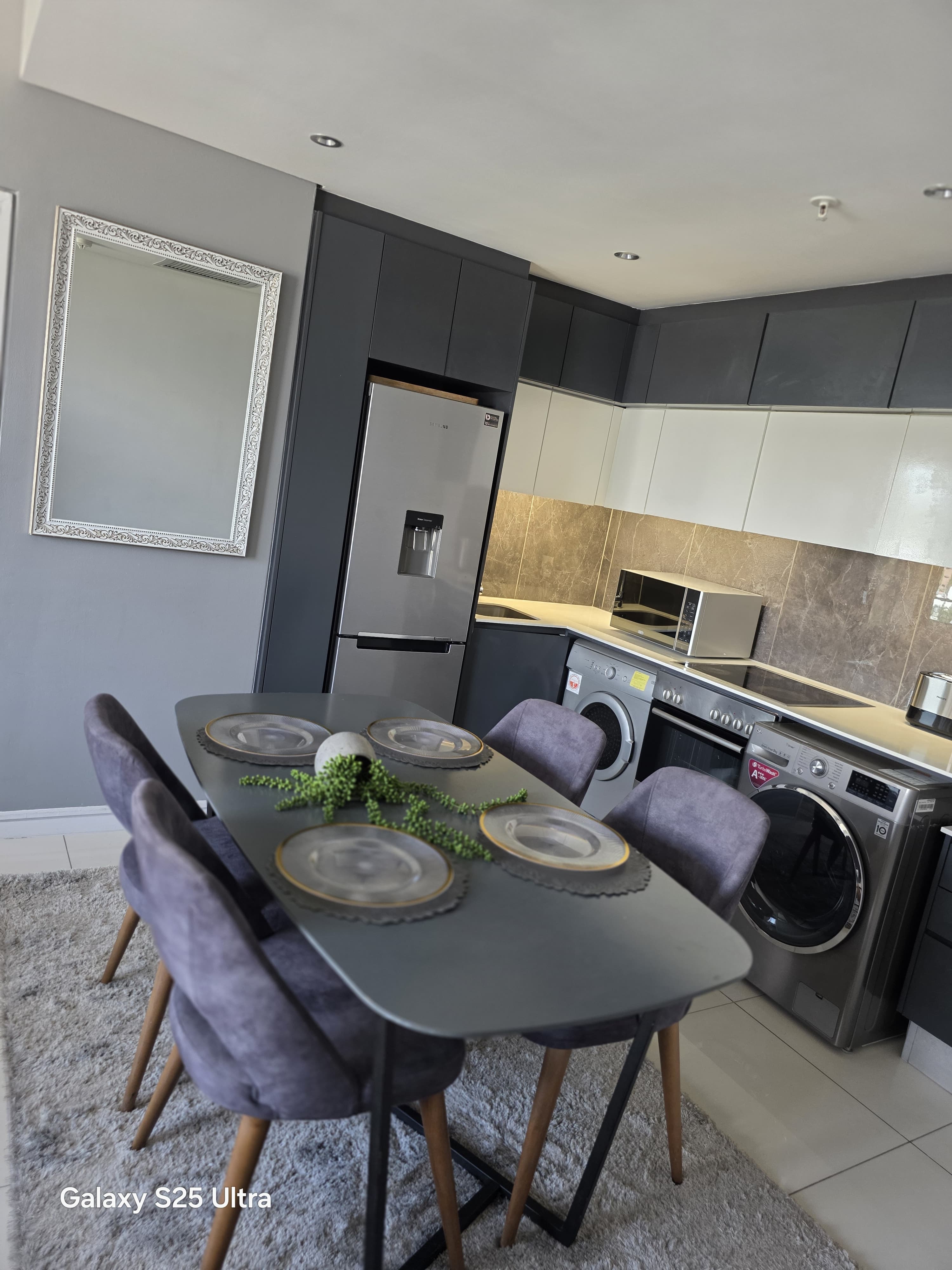 Fully equipped modern kitchen and dining area in apartment