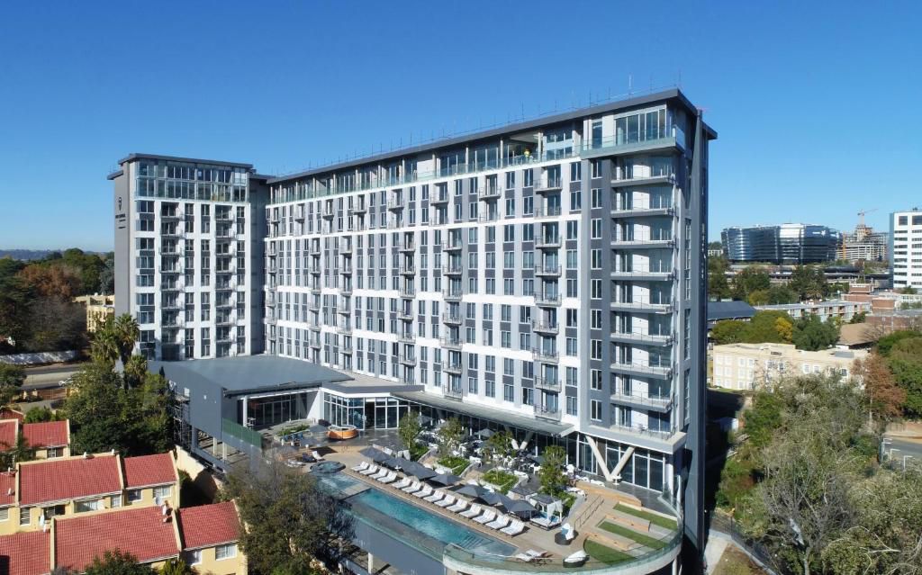 Aerial view of The Capital Hotel building with rooftop pool