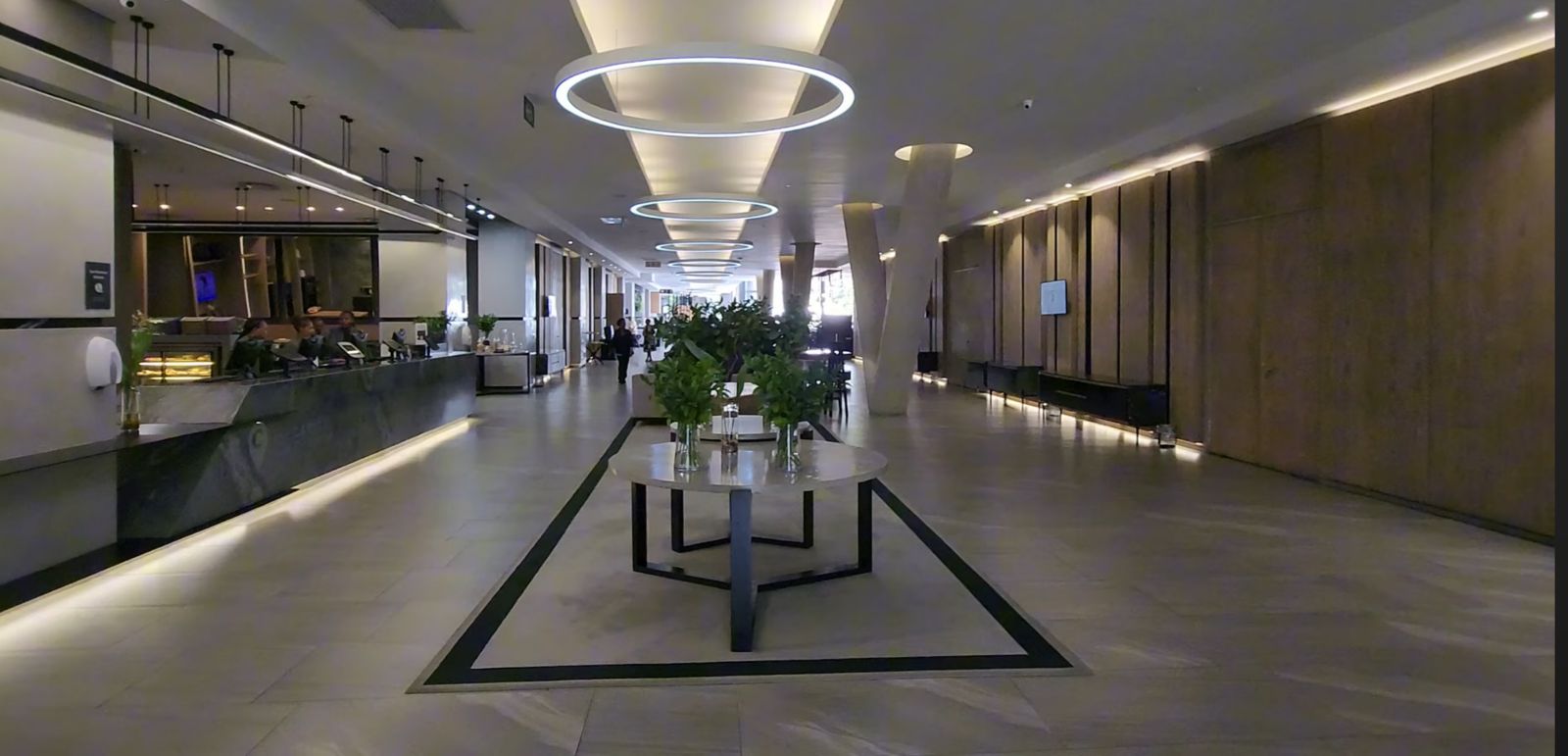 Elegant hotel lobby with circular lighting and reception desk