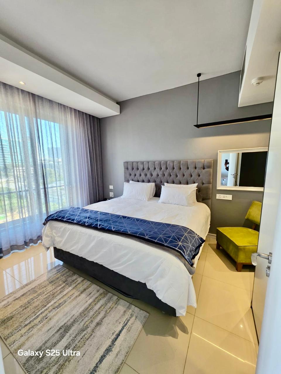 Luxurious master bedroom with king bed and city view
